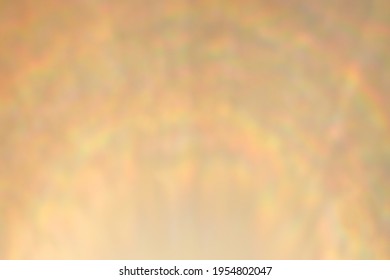 Rainbow lens flare. Abstract defocused golden background.