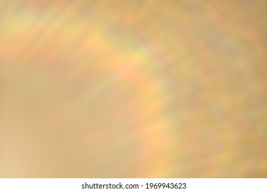 Rainbow lens flare. Abstract defocused golden background.