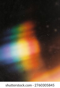 Rainbow light leak prism effect on dark vintage film grain texture
