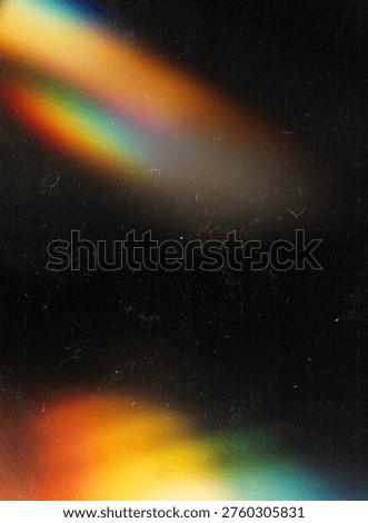 Rainbow light leak prism effect on dark vintage film grain texture
