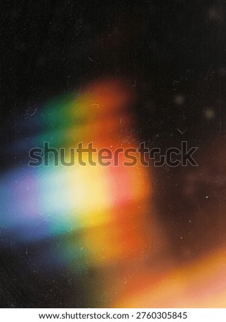 Rainbow light leak prism effect on dark vintage film grain texture