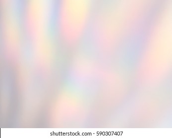 Rainbow Lights Refraction On A White Wall Background.