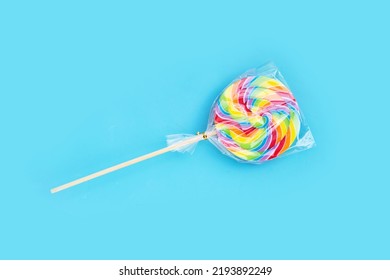 Rainbow Lollipop On Blue Background.