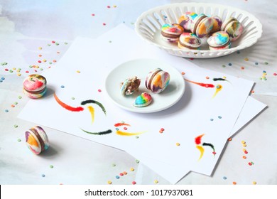Rainbow Macarons with Milk Chocolate Filling, on light blue background.