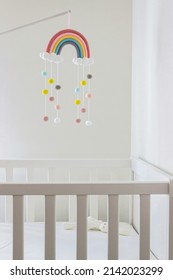 rainbow mobile hanging on crib in baby room  - Shutterstock ID 2142023299