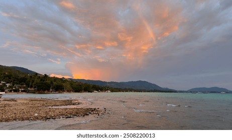 Rainbow with mountains. Sunset view. Island. Vacation. Relax. Nature. Landscape. Scenery. Sea. Cloudy sky. Background. Rocky beach. Trees.  - Powered by Shutterstock