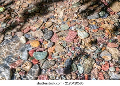 Rainbow multi-colored rocks in Avalanche creek leading towards Lake McDonald at Glacier National Park, Montana, USA
