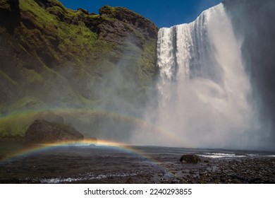 Rainbow near large waterfall landscape photo. Beautiful nature scenery photography with sky on background. Idyllic scene. High quality picture for wallpaper, travel blog, magazine, article - Shutterstock ID 2240293855