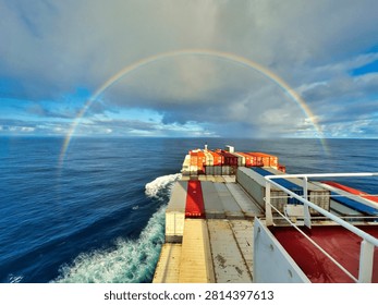 Rainbow in ocean over the container ship