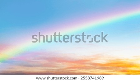 Rainbow and orange clouds in the evening sunset sky. A heavenly skyscape that gives peace and tranquility.