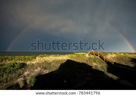 rainbow over the Atlantic from the dunes at the outer banks North Carolina