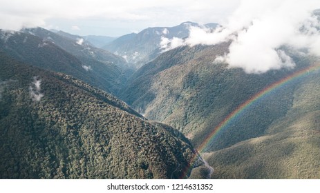 Rainbow Over The Mountains Valley In The Amazon Rainforest In Peru.