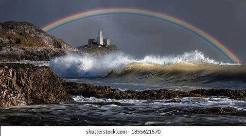 A rainbow over Mumbles lighthouse at Bracelet Bay on the Gower peninsula in South Wales, UK