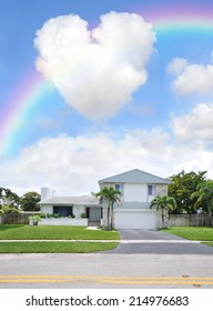 Rainbow over Suburban Back Split Style home in residential neighborhood USA Blue Sky Clouds