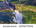 Rainbow over Victoria Falls in Zimbabwe, sunny day in Africa