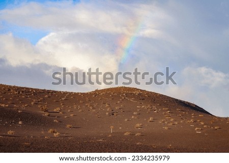 A rainbow overlooking Devastation Trail at Hawaii Volcanoes National Park