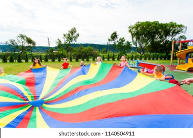 Rainbow Parachute Waived By Kids