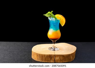 rainbow paradise cocktail with three color curacao blue drink, isolated on black background