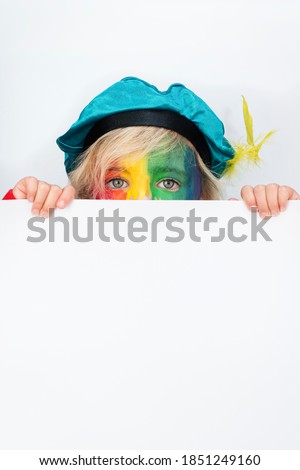 Rainbow Piet looking over a white paper. Commercial isolated Sinterklaas cutout