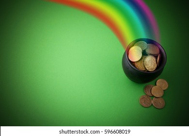 Rainbow pot of gold on green background