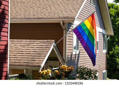 Rainbow Pride Flag On The Front Of A Residential House, With Space For Text On The Left