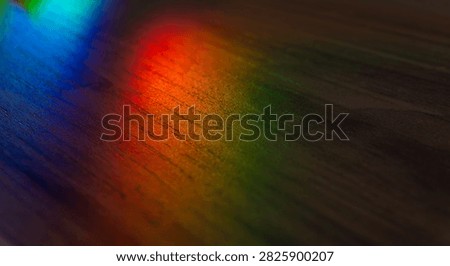 Rainbow prism light reflection on dark wood. Spectral refraction lines, colorful light beam, optical prism effect. prism, rainbow, light.