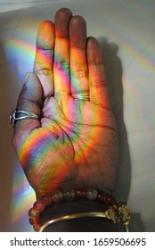 Rainbow reflection pattern on hand