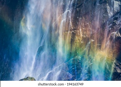 A Rainbow Shining In Of The Mist Of A Waterfall