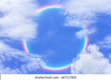 Rainbow Sky Beautiful Corona Full Circle Behind The Soft White Fluffy Clouds In The Blue Sky