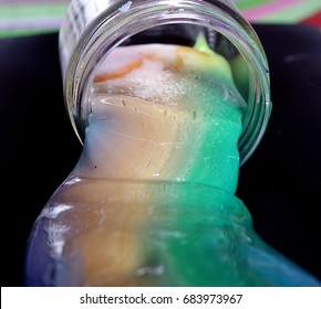 Rainbow Slime Spilling Out Of Clear Jar