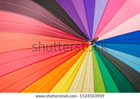 Rainbow spectrum multicolored texture of an umbrella as background.