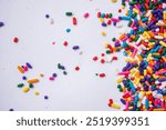 Rainbow sprinkles on white background