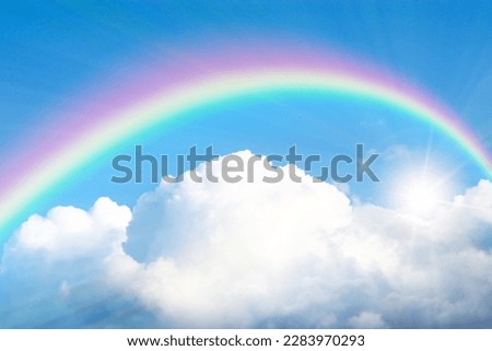 Rainbow and sun rays shining through clouds in blue sky. stretch ceiling decoration and wallpaper image