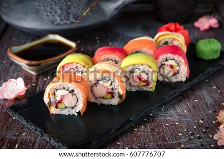 Rainbow Sushi Roll with salmon, eel, tuna, avocado, royal prawn, cream cheese Philadelphia, caviar tobica, chuka. Sushi menu. Japanese food.  Stockfoto © 