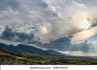 The rainbow tries to break through through clouds.