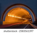 The Rainbow Tunnel Northbound Entrance with Car Light Trails in Sausalito, California.