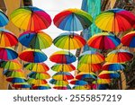 Rainbow umbrellas hanging over the street in Chueca Barrio, Madrid, Spain, for Gay Pride