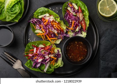 rainbow vegetarian lettuce wraps  on black plate, top view