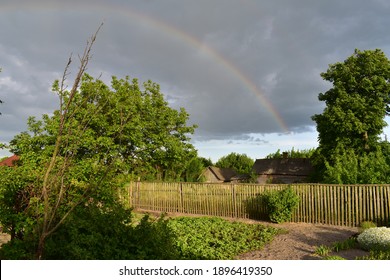Rainbow in the village Kazimirawka, Belarus - Shutterstock ID 1896419350