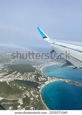 A  rainbow from the window of an airplane