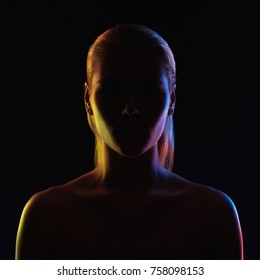 Rainbow woman silhouette, woman in colorful bright lights posing in studio. Art design, colorful girl Over black background