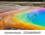 Rainbow-colored hot springs- Visit geothermal areas with rainbow-colored hot springs, such as the Grand Prismatic Spring in Yellowstone National Park, showcasing vibrant hues caused by mineral-rich