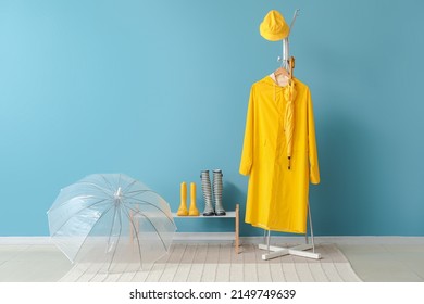 Raincoat, gumboots and umbrella in hallway - Powered by Shutterstock