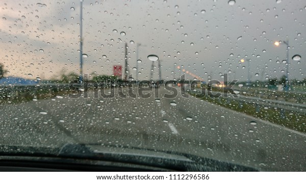 Raindrop on the car\
glass with blurred background. Rain drops on the car glass. Water\
drops on the car glass.\
