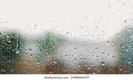 raindrop on the window in autumn a background. wet glass rain drops rainy sky blurred background close-up. rain in the window on the background of the sky lifestyle blurred plan - Powered by Shutterstock