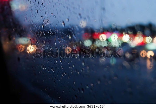 Raindrop on the window at night with colorful
light on the street