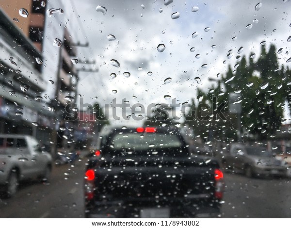 Raindrop outside the car in raining
day for background at Street traffic of working day in rainy day
thailand.Good view from driver seat.Selective
focus.