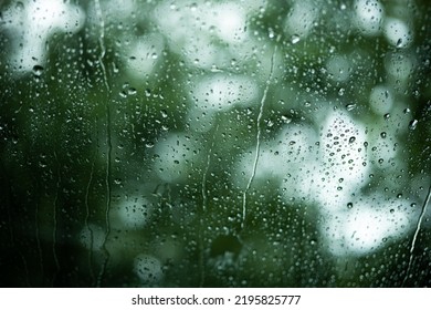 Raindrop Running Down A Car Windshield Glass. Close Up Shot, Shallow Depth Of Field, Green Nature Background, No People