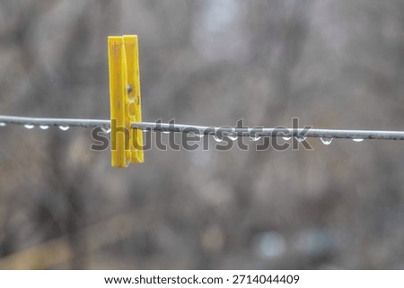 raindrops and clothespins on a wire during rain