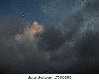 Raindrops with dark clouds in background.